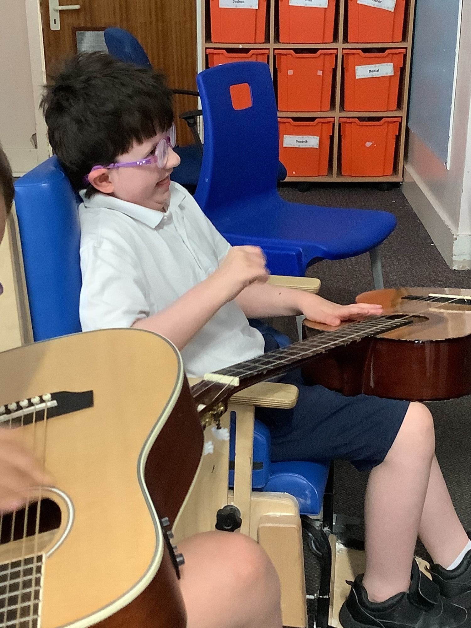 Pupil sitting with a guitar 