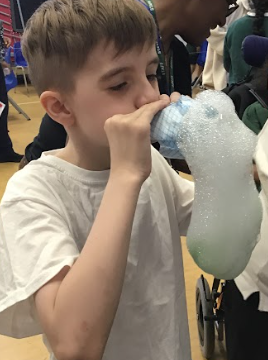 Pupil making bubbles through bottle experiment 