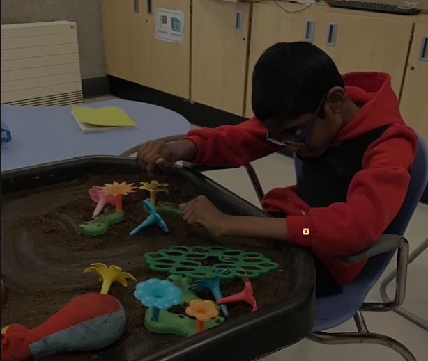 Pupil doing a sensory activity in class