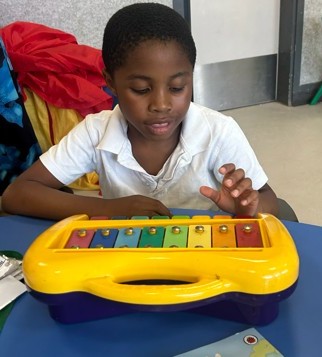 Pupil using musical instrument 