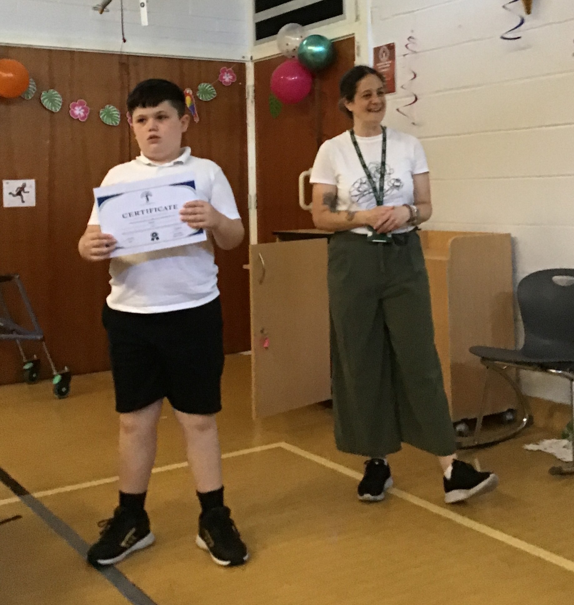 Pupil holding certificate at graduation ceremony