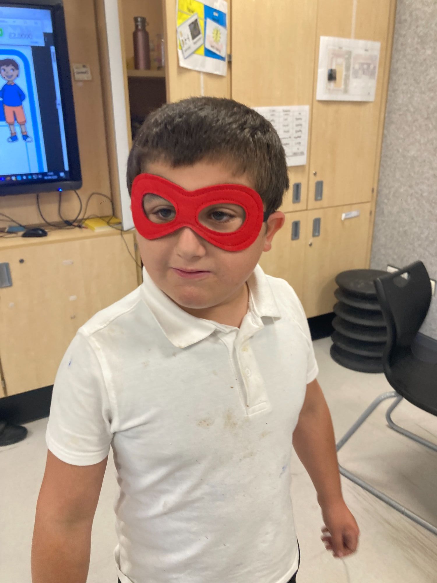 Pupil wearing superhero mask 