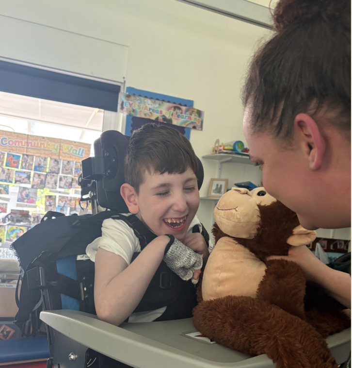 Pupil with toy monkey