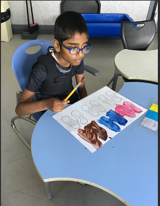 Pupils painting in classroom