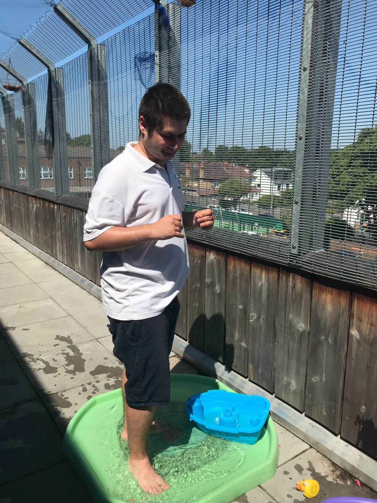 Pupil standing in water tray to keep cool