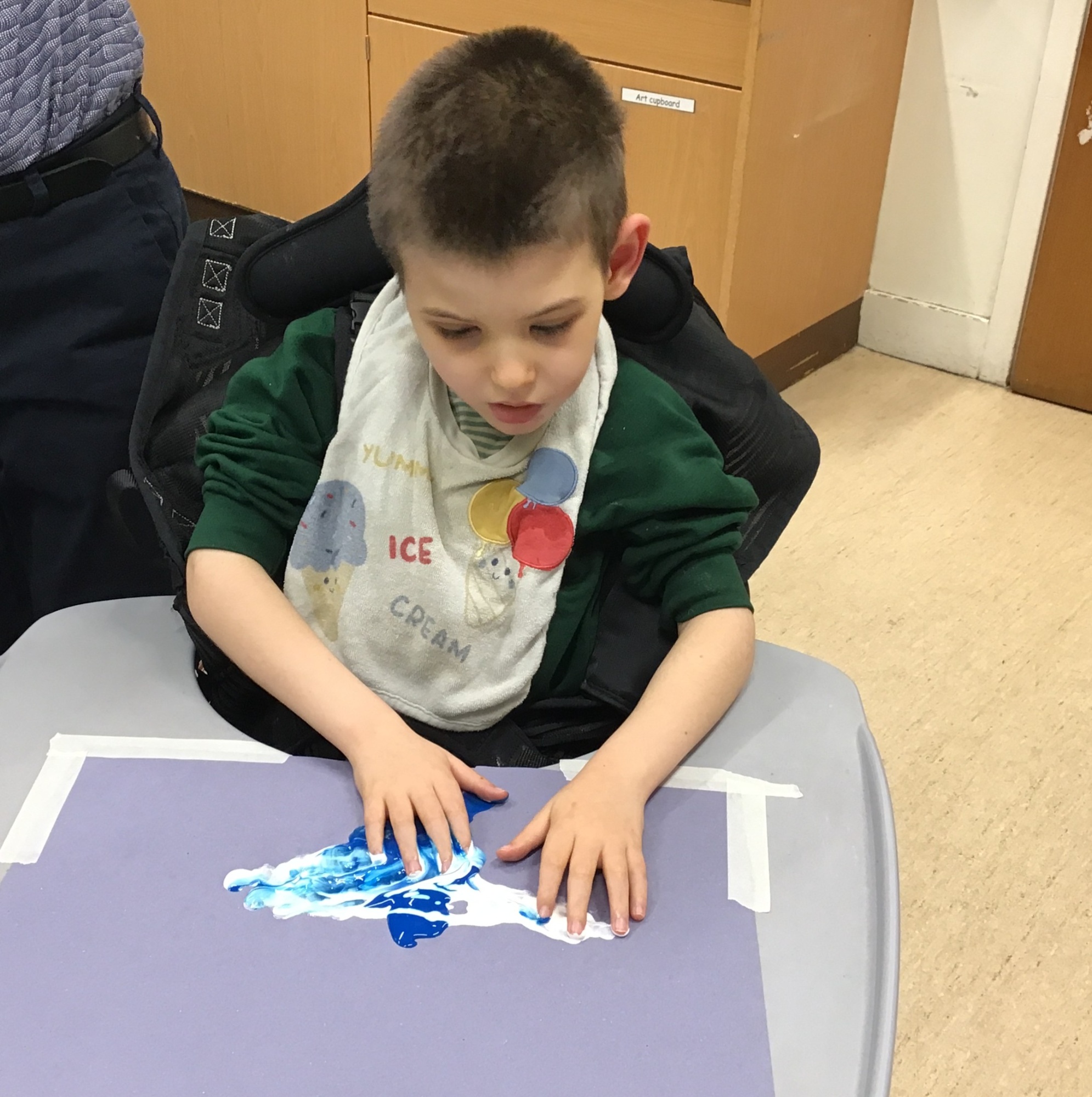 Pupil doing art activity with his hands 
